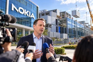 Man in a suit speaks to reporters outside Nokia headquarters with a construction site in the background.